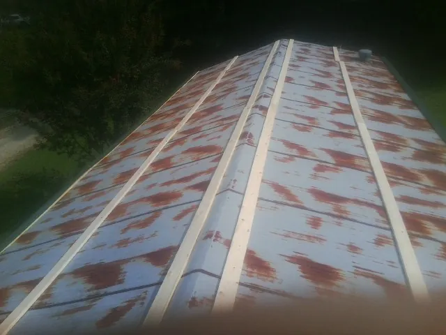 Rusted metal roof panels with new wood purlins before replacement — Storm Damage Roof Repair in Charleroi by Roofing Brothers