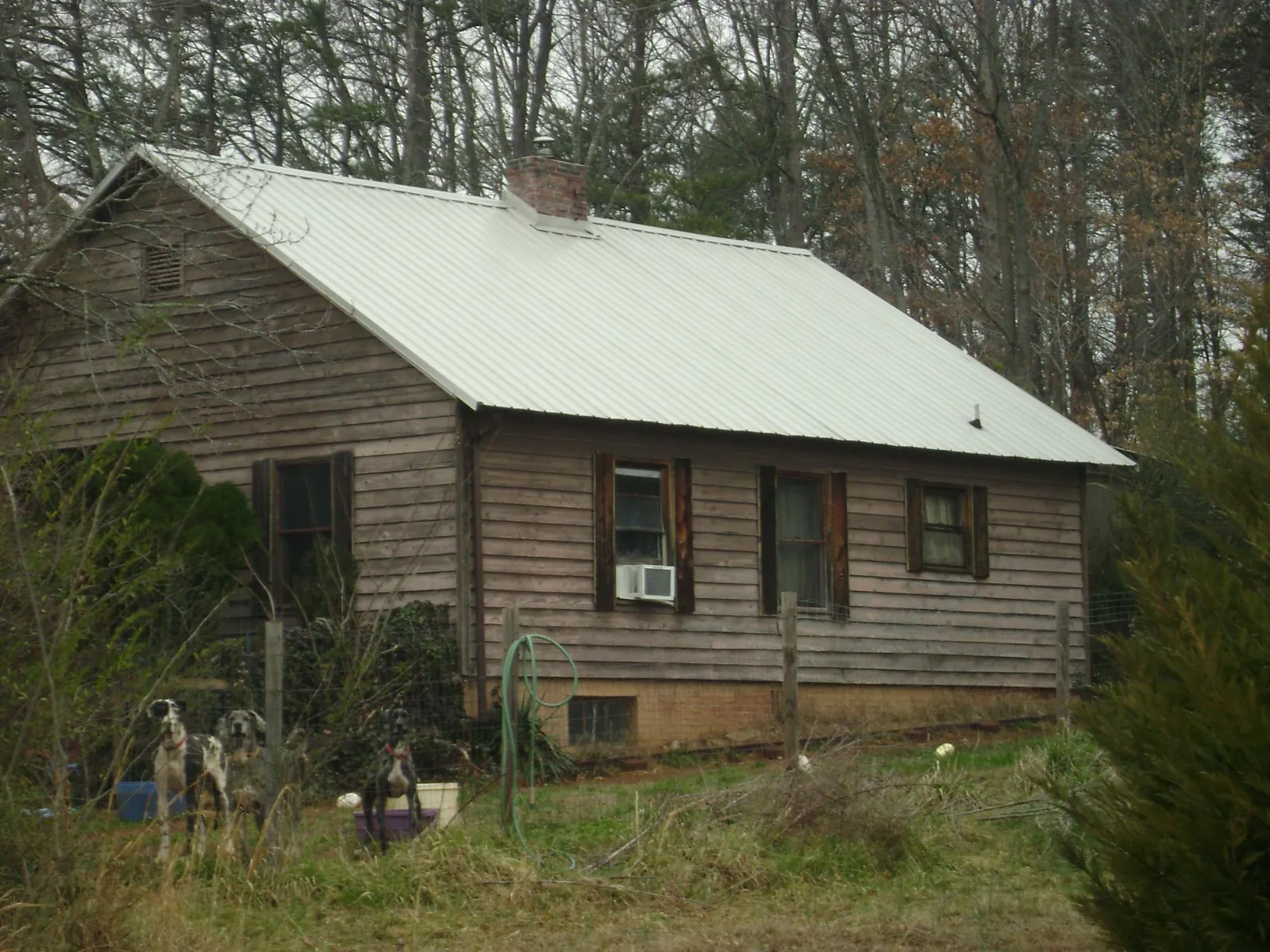 White metal roof on an old wood sided farmhouse, from a Metal Roof Installation job in Charleroi